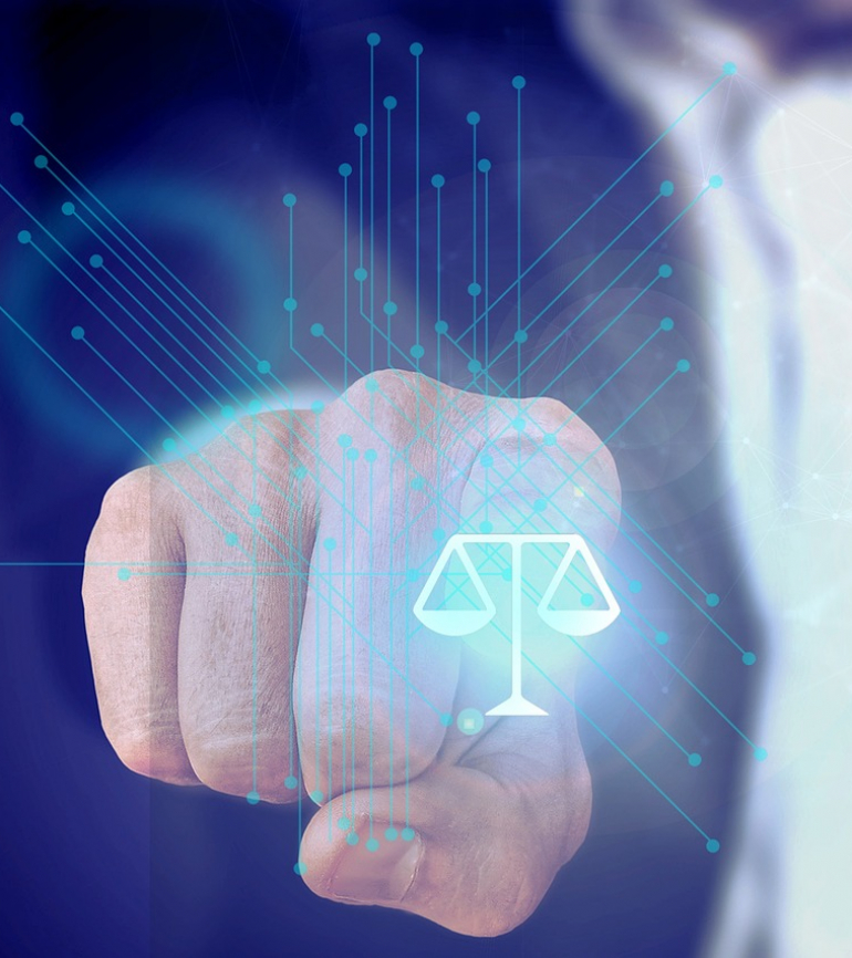 Hand klickt auf fiktiven Button mit einer Waage, die für Justiz steht